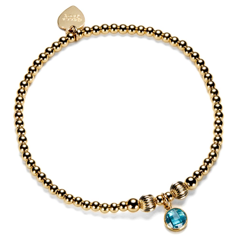 Gold-filled beaded bracelet with a blue coloured cubic zirconia charm, representing a December birthstone.