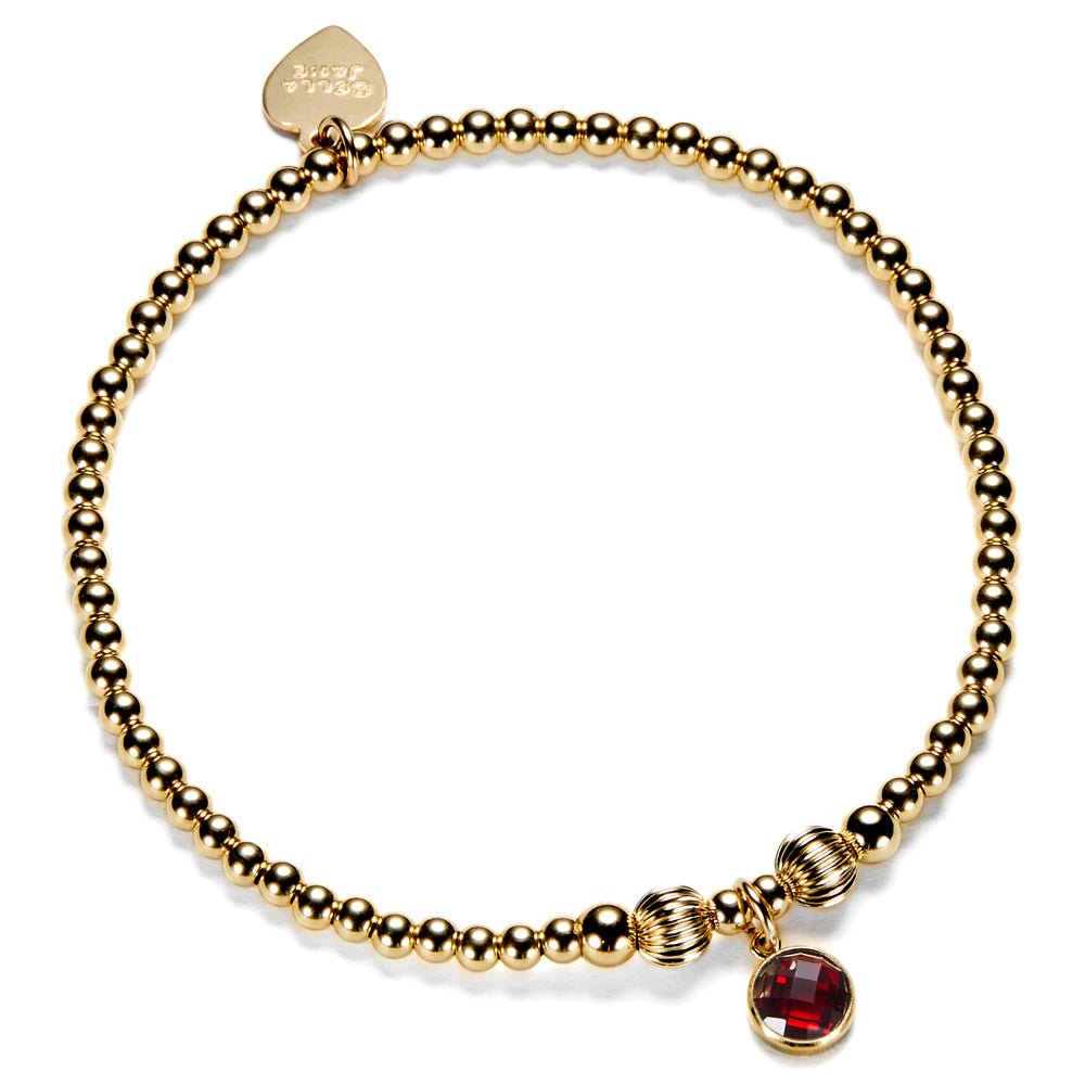 Gold-filled beaded bracelet with a red cubic zirconia charm, representing a January birthstone.