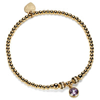 Gold-filled beaded bracelet with a purple cubic zirconia charm, representing a June birthstone.