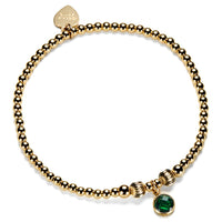 Gold-filled beaded bracelet with a green cubic zirconia charm, representing a May birthstone.