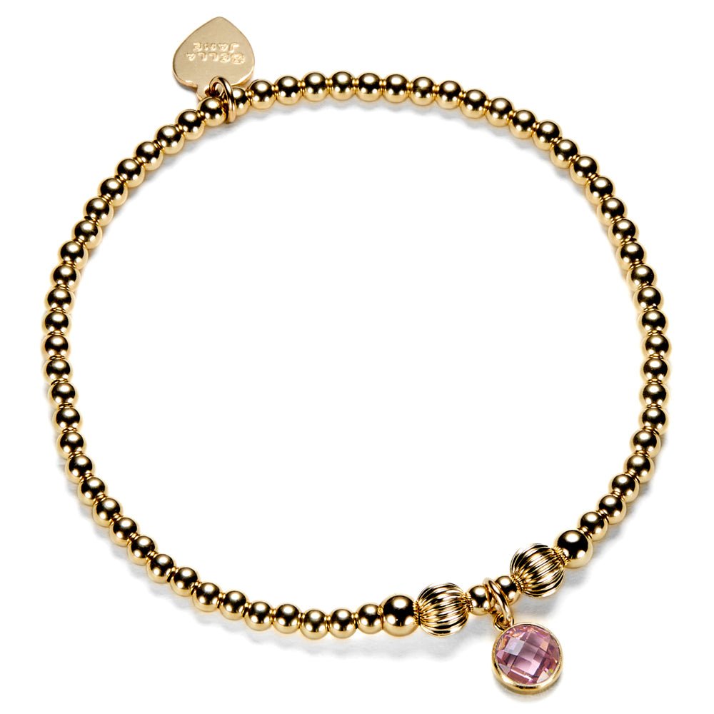 Gold-filled beaded bracelet with a pink cubic zirconia charm, representing an October birthstone.