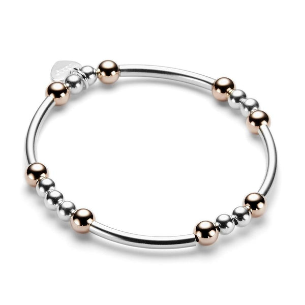 Sterling silver and rose gold beaded bracelet with noodle shaped and round beads on a white background