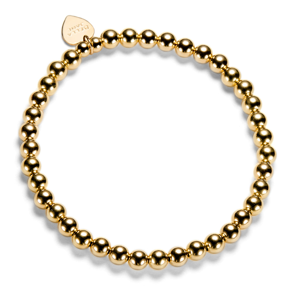 gold beaded stacking bracelet with Bella Jane branded heart tag on a white background.