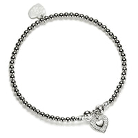 Silver beaded bracelet with heart-shaped charm on a white background