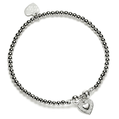 Silver beaded bracelet with heart-shaped charm on a white background