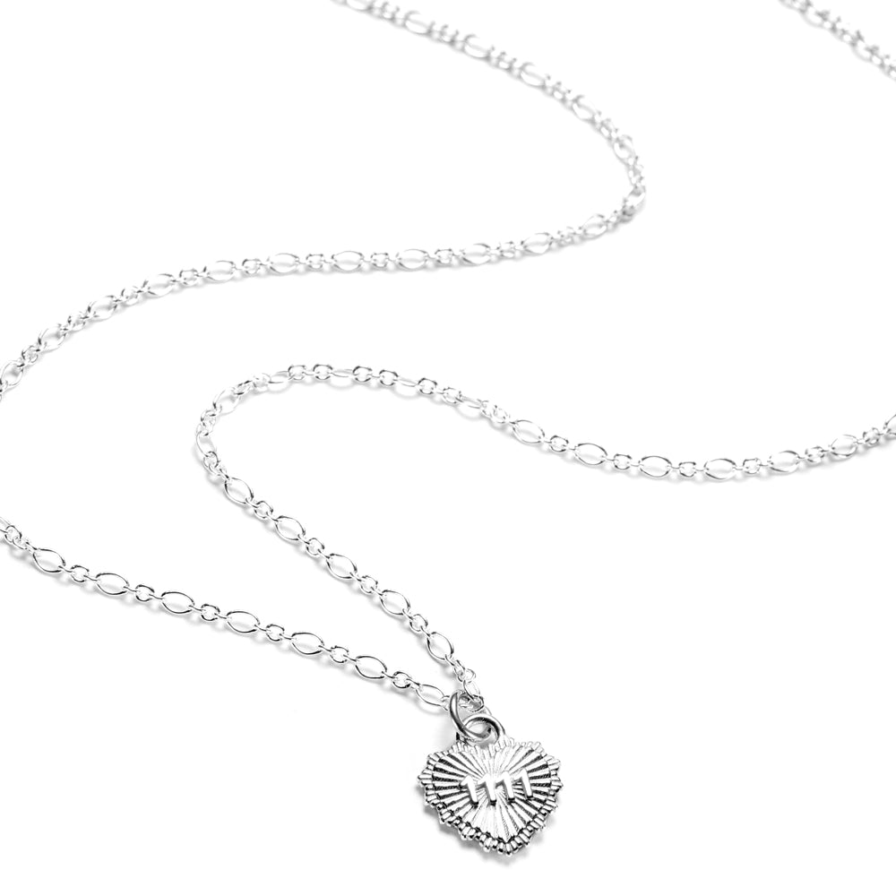 A close up of a sterling silver necklace with a heart-shaped pendant, featuring the angel number 1111, on a white background.