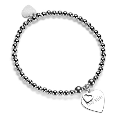Silver beaded bracelet with a heart-shaped charm featuring the word Bestie on a white background