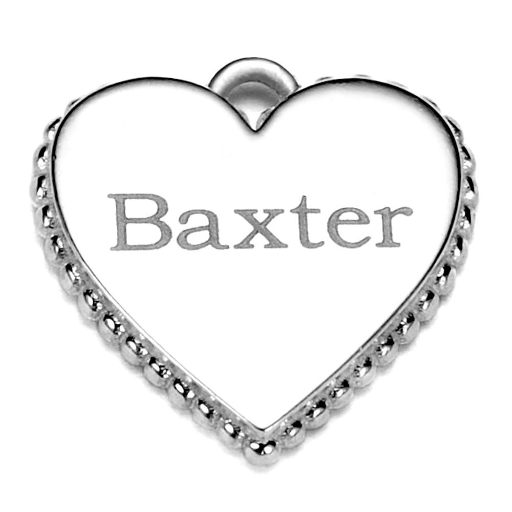 Heart shaped charm with a dogs name engraved on it pictured on a white background.