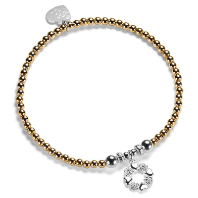 A Bella Jane gold-filled and sterling silver beaded bracelet on a white background, featuring a silver wreath-shaped charm with alternate little hearts and roses