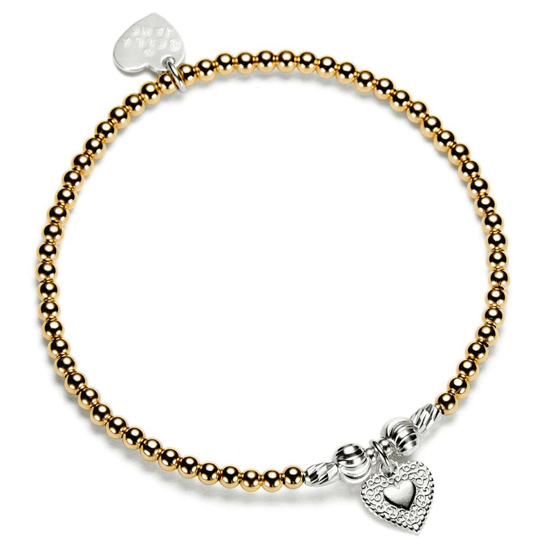 Gold beaded bracelet with heart-shaped charm on a white background