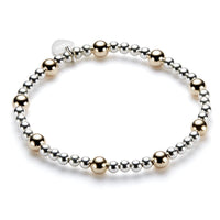 Bracelet with alternating gold and silver beads on a white background