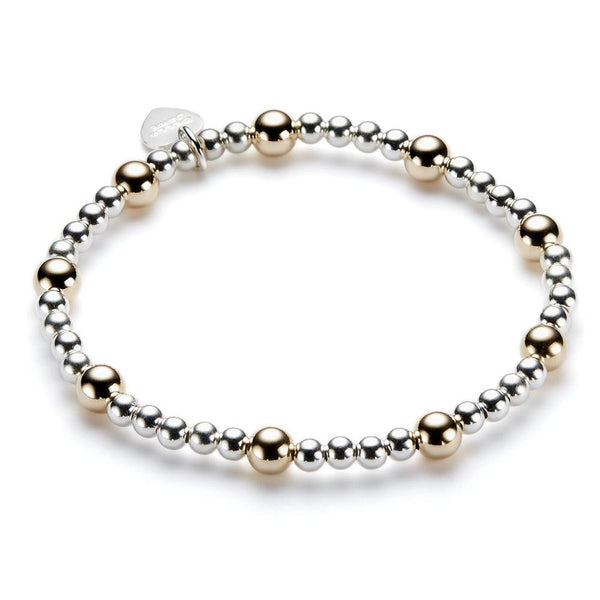 Bracelet with alternating gold and silver beads on a white background