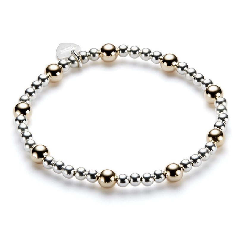 Bracelet with alternating gold and silver beads on a white background