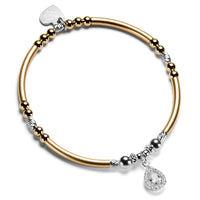Gold and silver beaded bracelet with a sparkly cubic zirconia shaped charm, on a white background