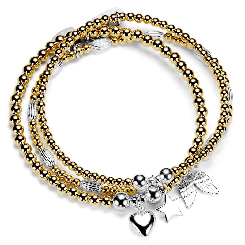 Stack of gold and silver beaded bracelets with charms on a white background