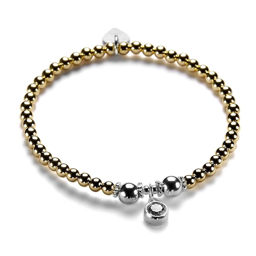 A gold and silver bracelet with a cubic zirconia sparkly charm pictured on a white background.
