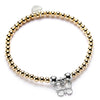 A gold beaded bracelet with a silver butterfly charm.