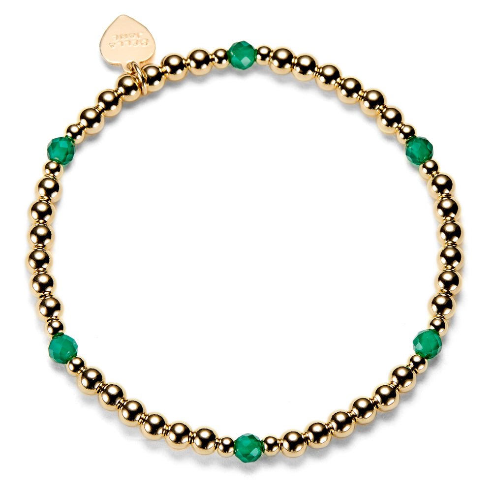 Gold beaded bracelet with green beads on a white background
