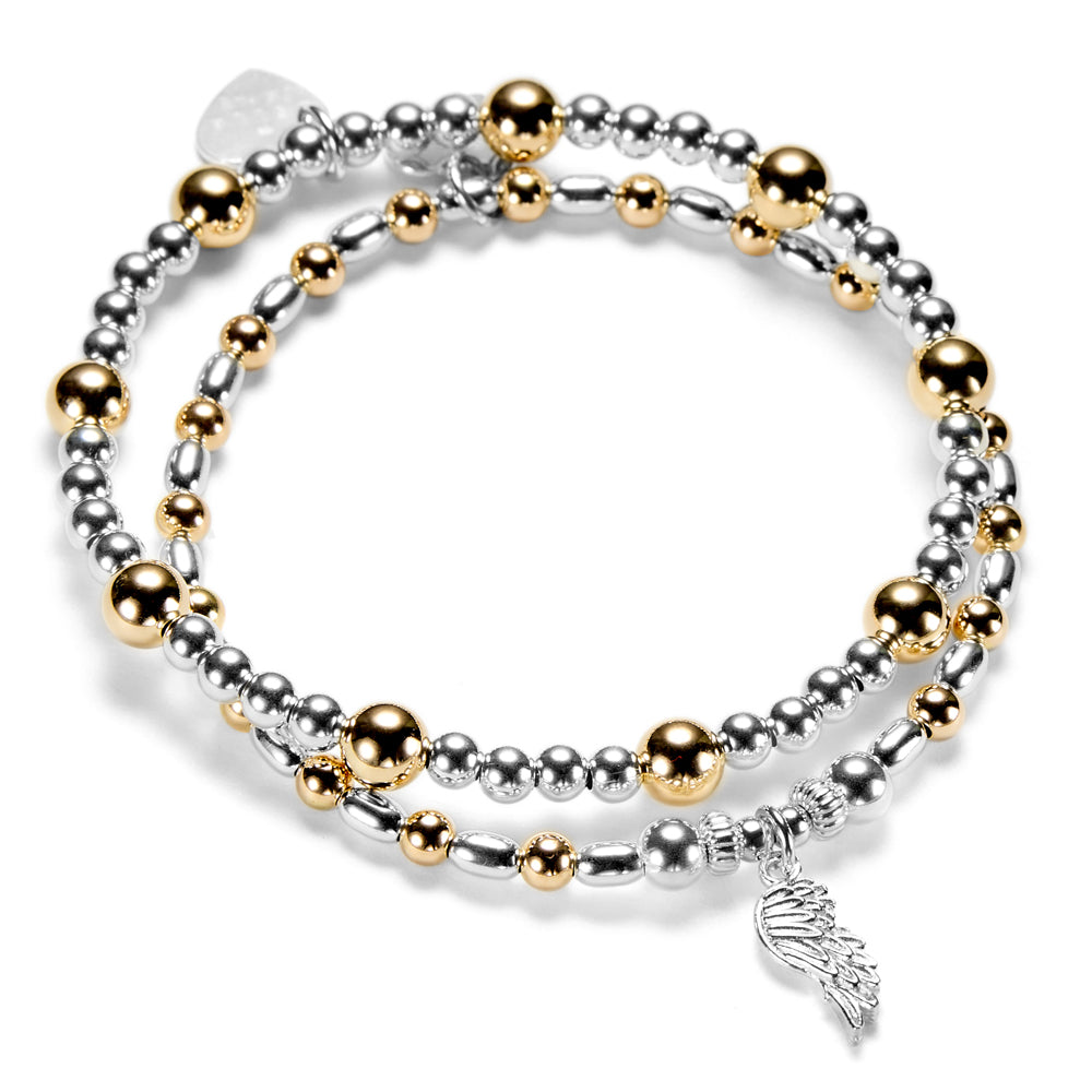 Silver and gold mixed metal beaded bracelet duo with a silver angel wing charm on a white background