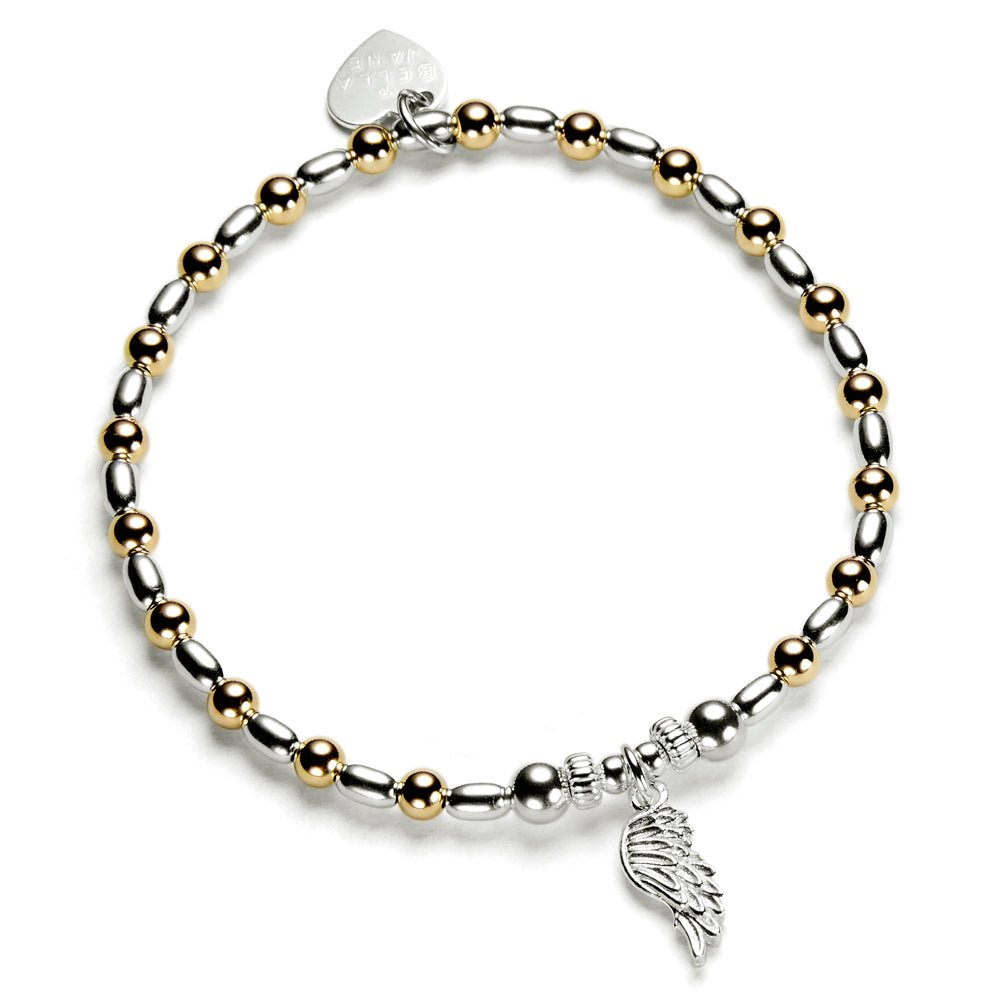 Bracelet with gold and silver beads and a wing charm on a white background