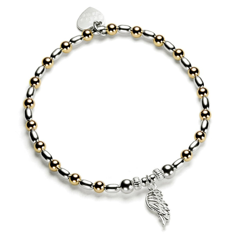 Bracelet with gold and silver beads and a wing charm on a white background