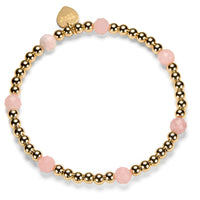 Beaded stacking bracelet with gold-filled and pink opal beads, with Bella Jane branded gold-filled heart tag, on a white background.