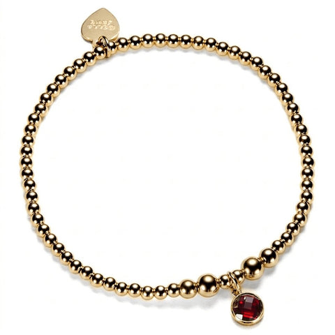 Gold-filled beaded bracelet with a red cubic zirconia charm, representing a January birthstone.