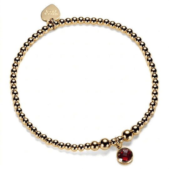 Gold-filled beaded bracelet with a red cubic zirconia charm, representing a January birthstone.