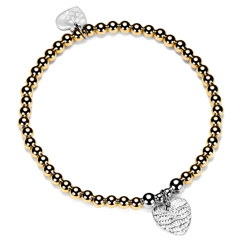 Gold and silver beaded bracelet with heart-shaped charm on a white background