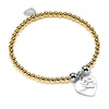 A gold beaded bracelet with a silver heart-shaped charm with the words 'Love Luck Happiness' engraved pictured on a white background