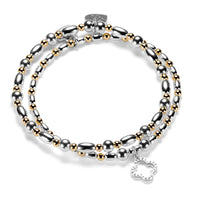Silver and gold mixed-metal beaded bracelet duo featuring an open style, silver studded four leaf clover charm on a white background