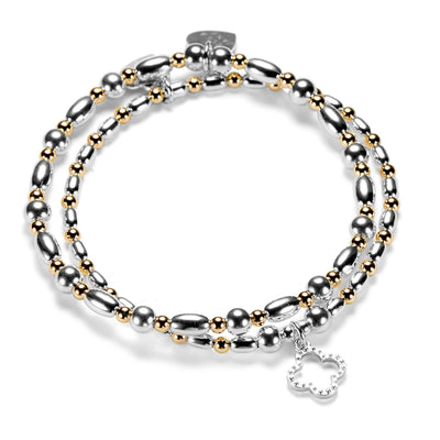 Silver and gold mixed-metal beaded bracelet duo featuring an open style, silver studded four leaf clover charm on a white background