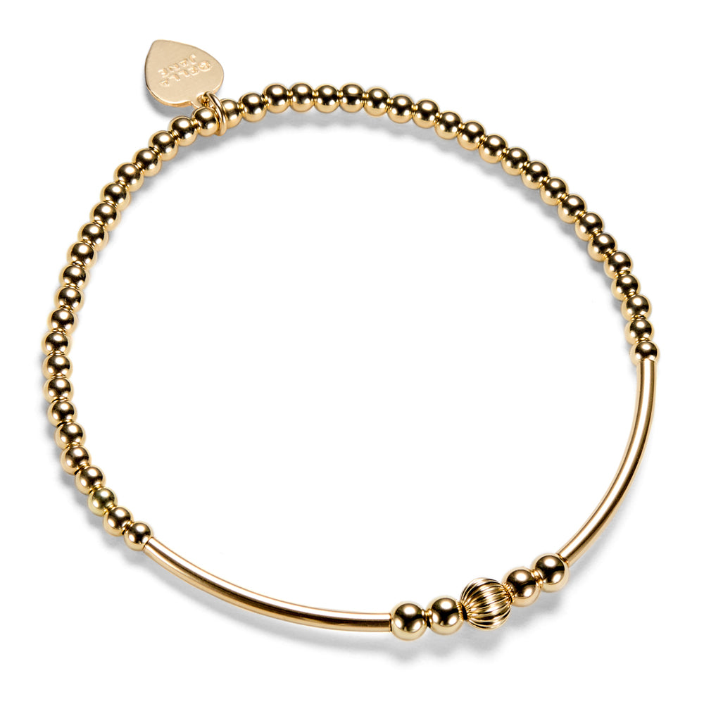 A gold-filled beaded stacking bracelet with focal noodle beads, on a white background.