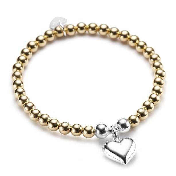 Gold beaded bracelet with a silver heart charm on a white background
