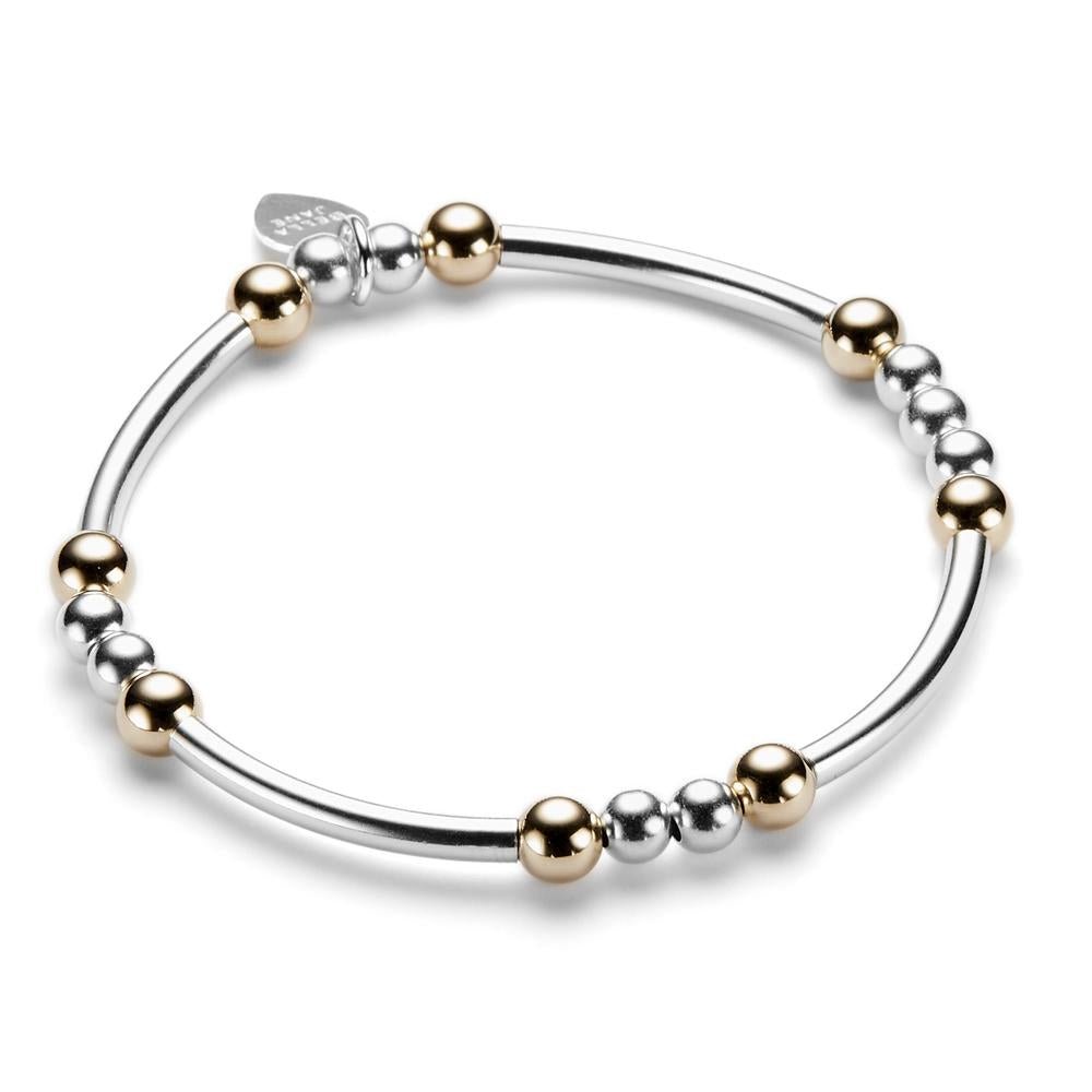 Sterling silver and gold-filled beaded bracelet with noodle shaped and round beads on a white background