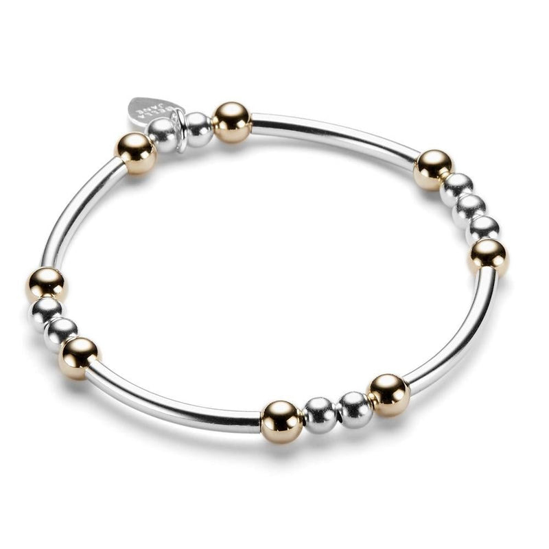 Sterling silver and gold-filled beaded bracelet with noodle shaped and round beads on a white background