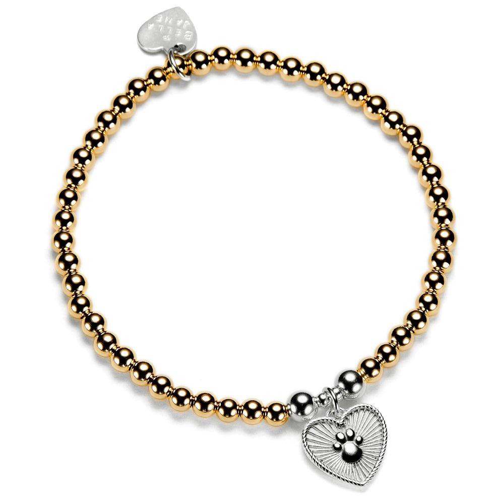 A gold stacking bracelet with a beaded design featuring a heart-shaped charm with a paw print design, displayed on a white background.