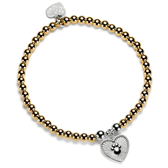 A gold stacking bracelet with a beaded design featuring a heart-shaped charm with a paw print design, displayed on a white background.