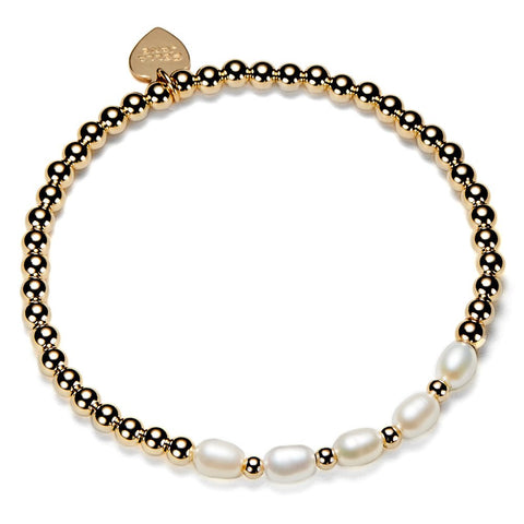 Gold beaded bracelet with white pearls on a white background