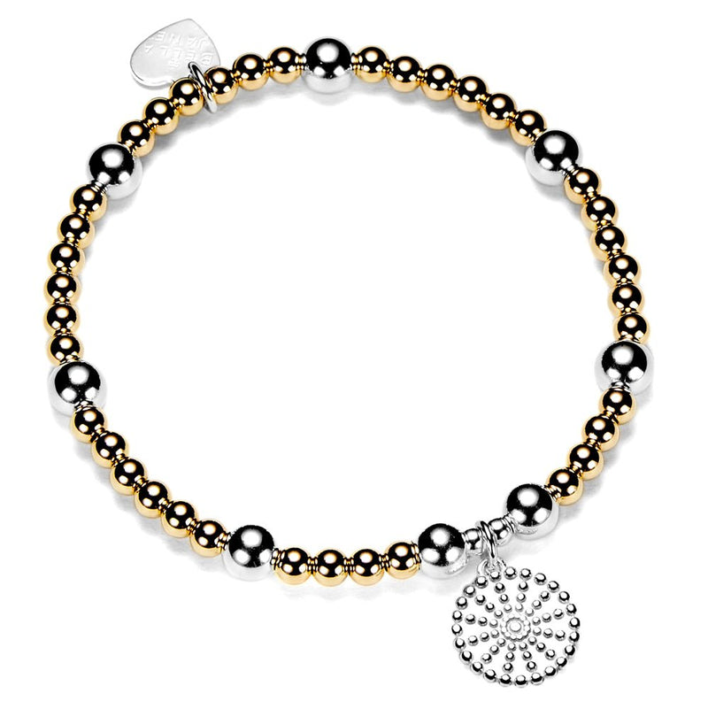 Bracelet with gold-filled and sterling silver round beads with a silver bobble disc shaped charm on a white background