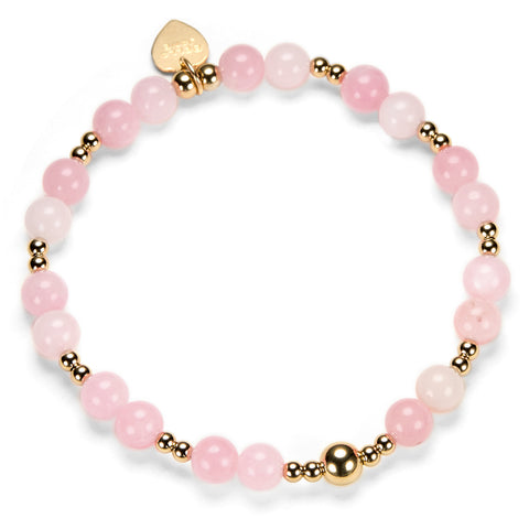 Pink beaded bracelet with gold accents on a white background