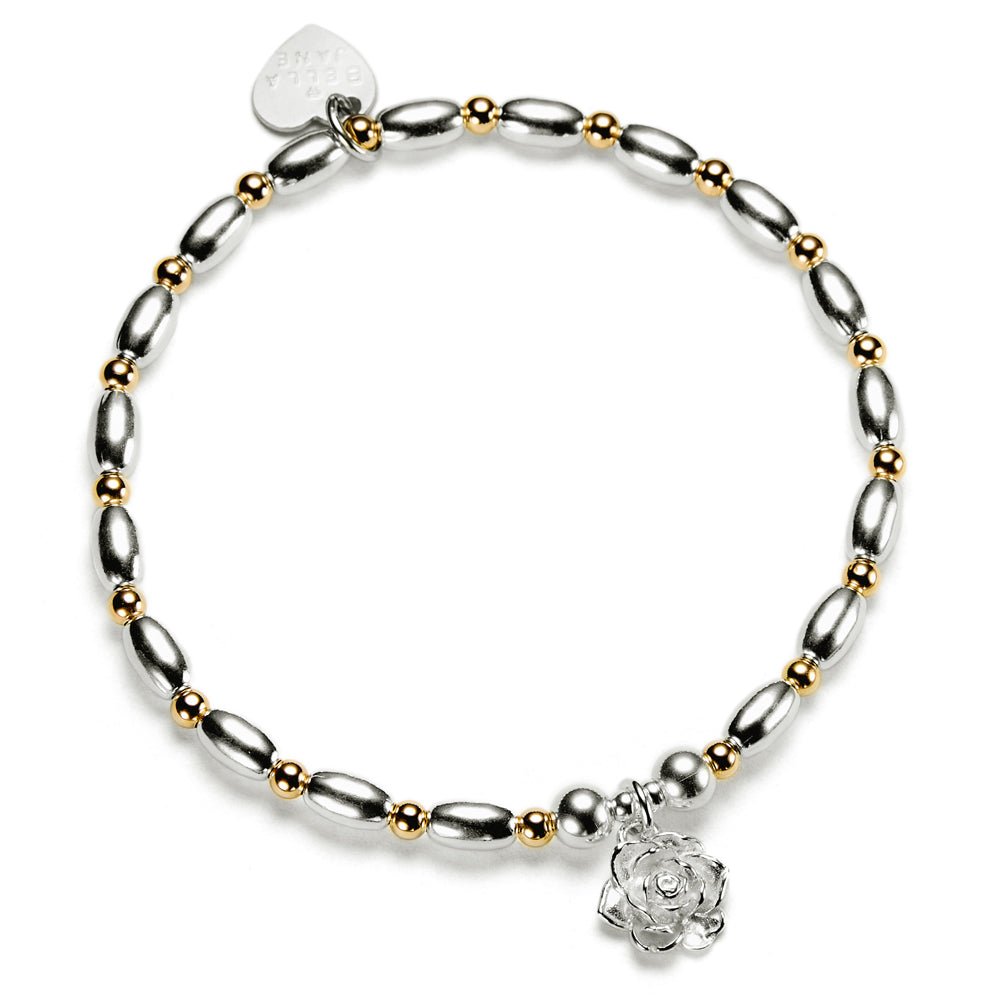 Silver and gold mixed metal beaded bracelet with a sterling silver flower charm, on a white background