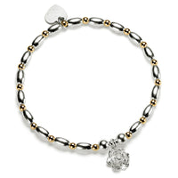 Silver and gold mixed metal beaded bracelet with a sterling silver flower charm, on a white background