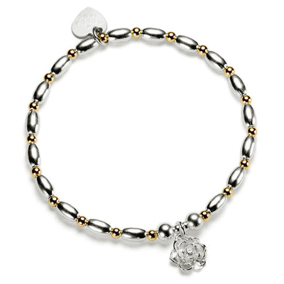Silver and gold mixed metal beaded bracelet with a sterling silver flower charm, on a white background
