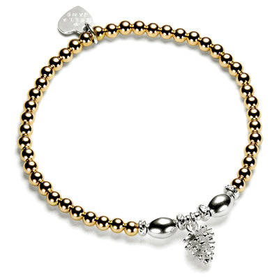 A gold-filled and sterling silver bracelet featuring a series of round and oval beads, a silver pine cone charm, and a heart-shaped tag, against a white background.