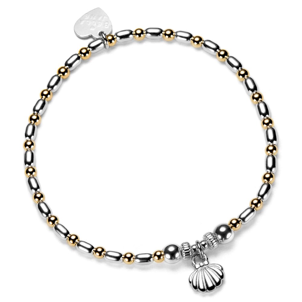 Bracelet with silver and gold beads with a silver shell charm, on a white background