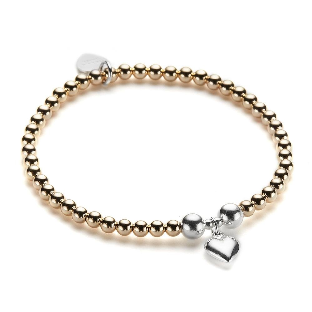 Gold beaded bracelet with silver heart charm on a white background