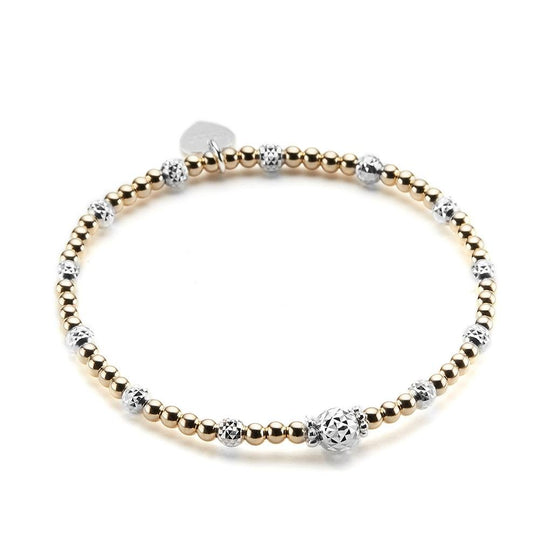 A gold and sterling silver mixed-metal stacking bracelet, featuring a focal silver faceted focal bead at the front and a branded Bella Jane heart tag at the back, displayed on a white background.