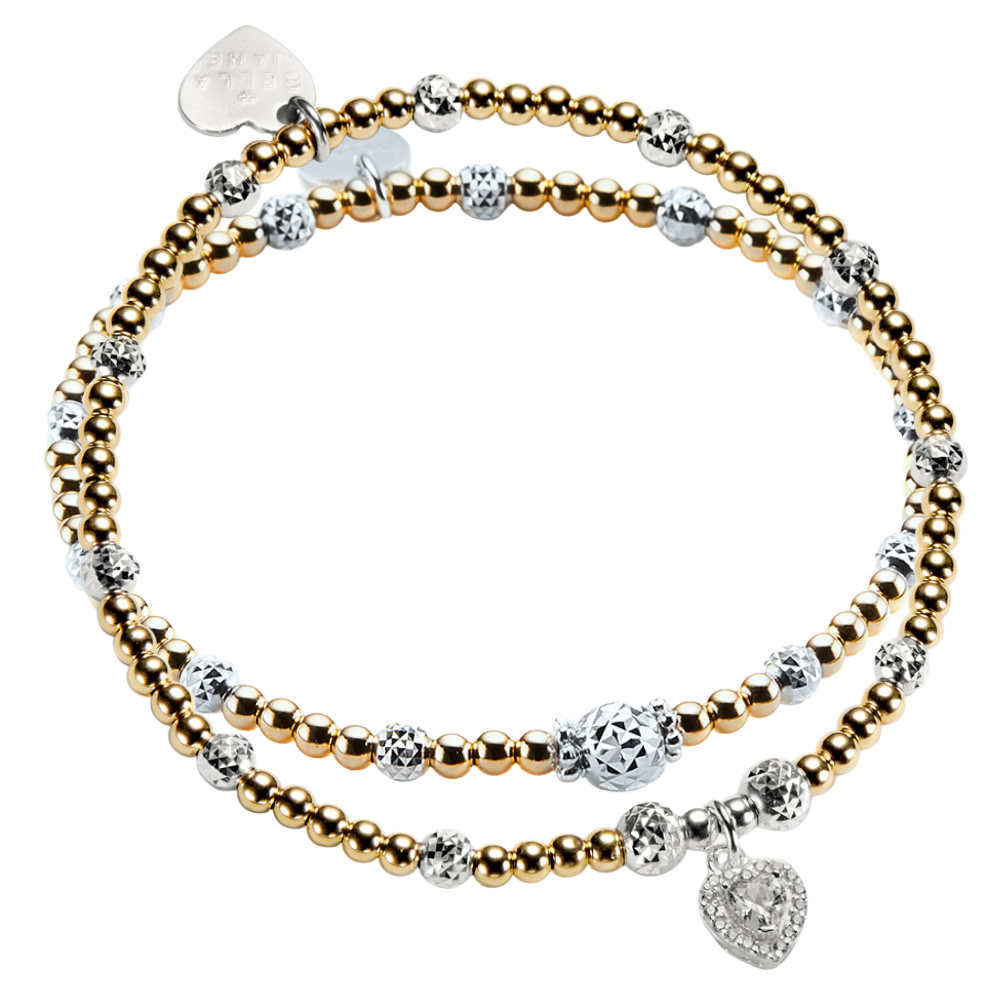 Two gold and silver mixed metal beaded stacking bracelets, one with a sparkly heart-shaped charm on a white background.