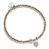 Gold beaded bracelet with a few silver beads and a silver and cubic zirconia heart charm, on a white background